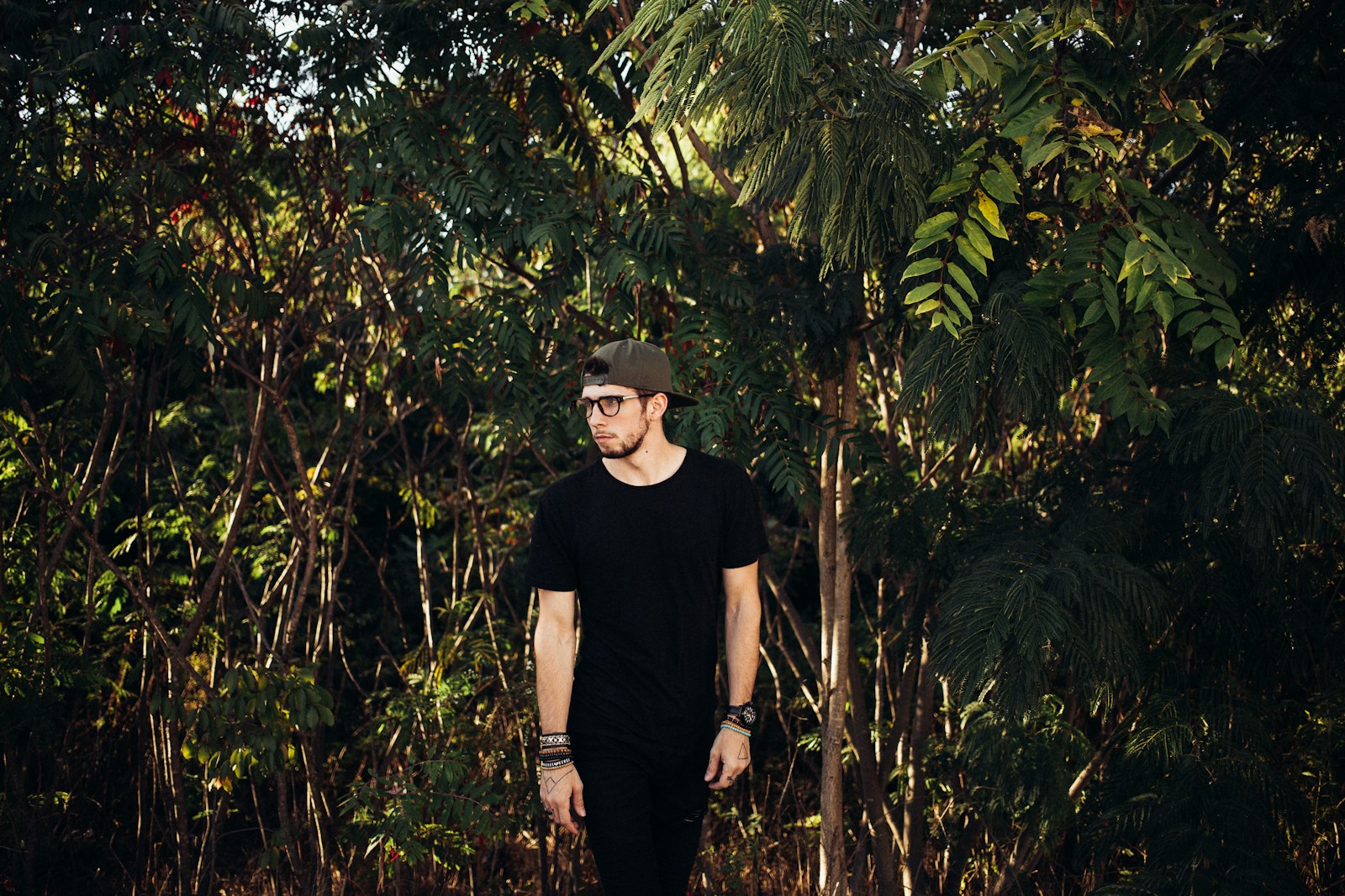 a man standing in front of a forest