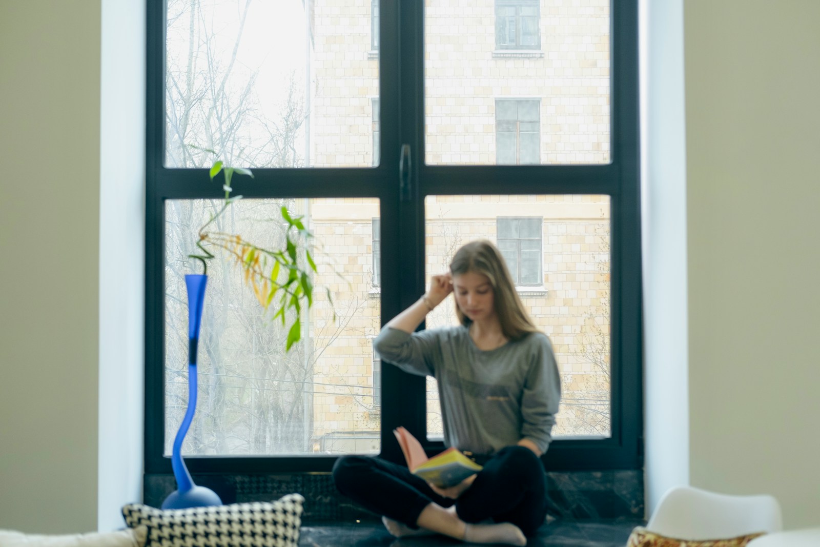 a person sitting next to a window