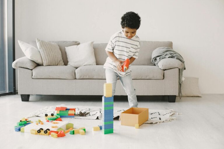 A cheerful child playing with colorful building blocks indoors.