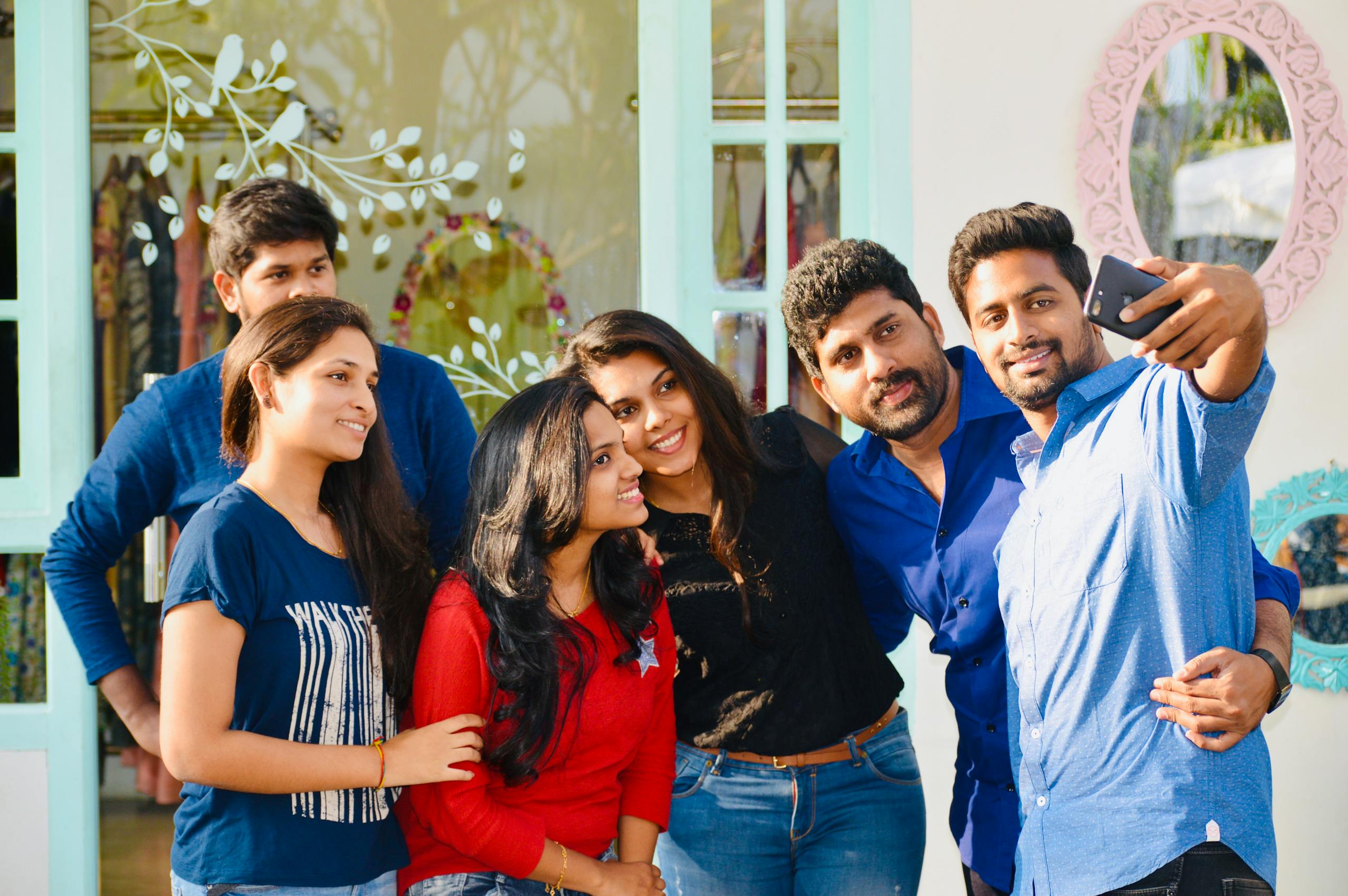 A cheerful group of friends capturing a memorable selfie together on a sunny day.