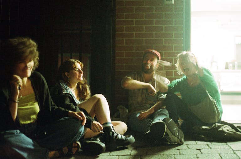 A group of friends sitting outside, enjoying a casual evening in Ipswich.