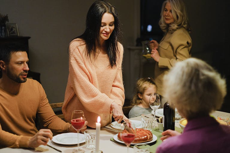 A joyful family dinner with multiple generations enjoying together around the table.