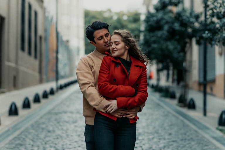A loving couple embraces on a charming street in Buenos Aires, capturing intimacy and urban romance.