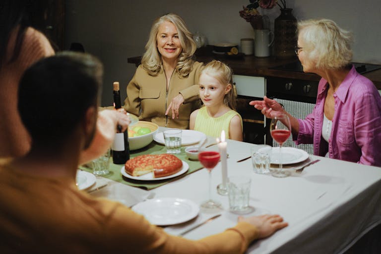 A multigenerational family enjoying dinner together at home, highlighting family bonds and togetherness.