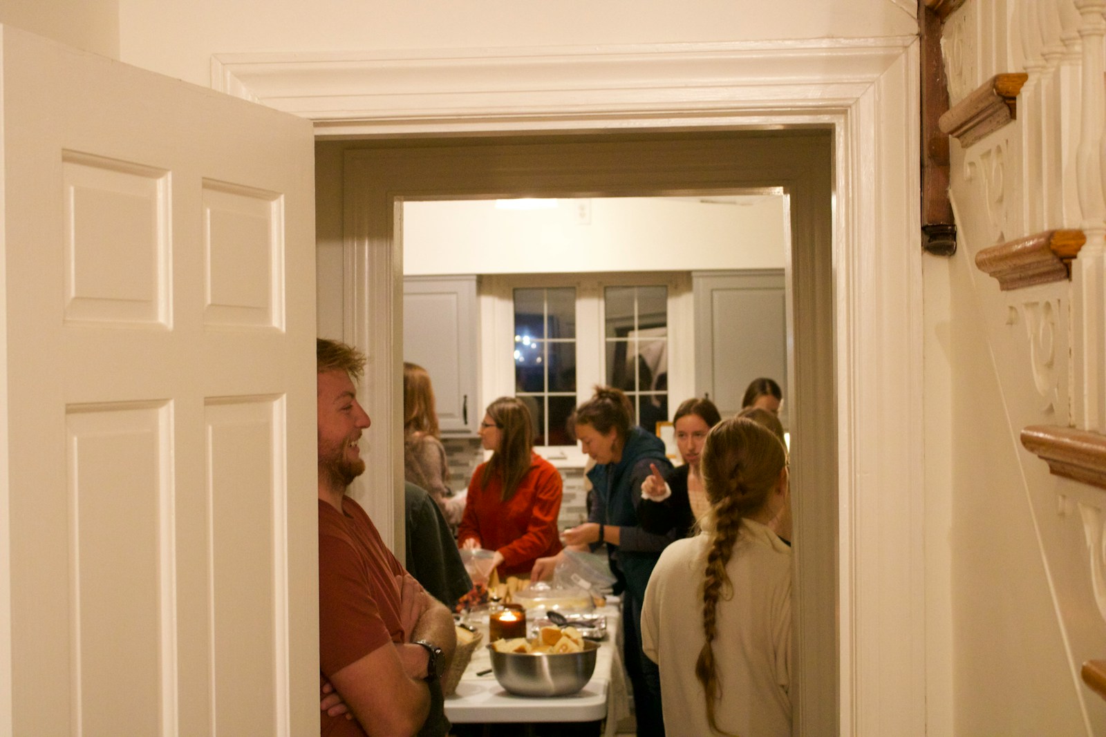 People gathered in a kitchen during a party.