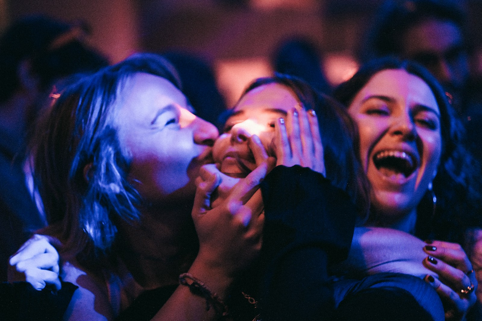 a group of women are laughing and laughing together