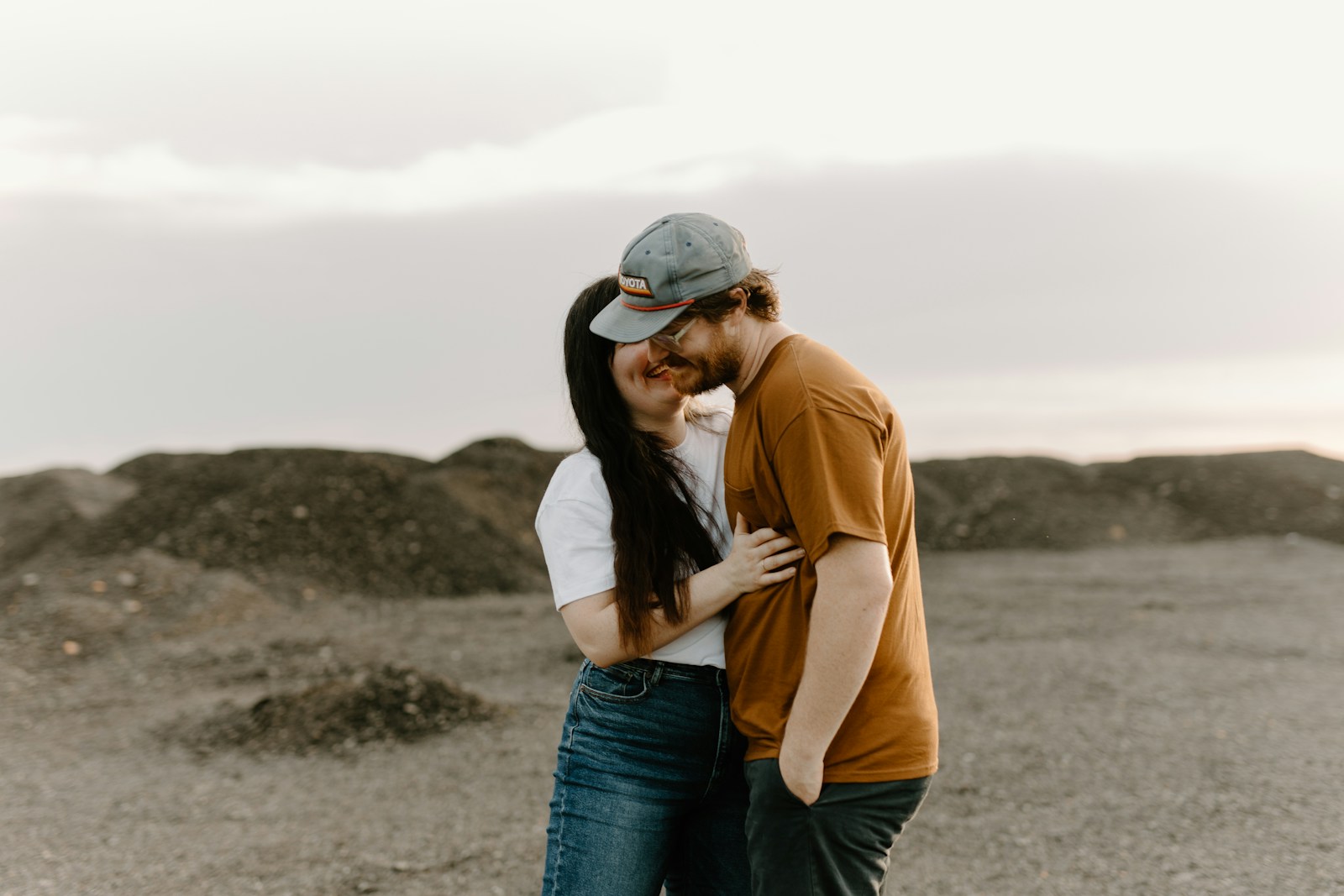 a man and a woman embracing in the desert