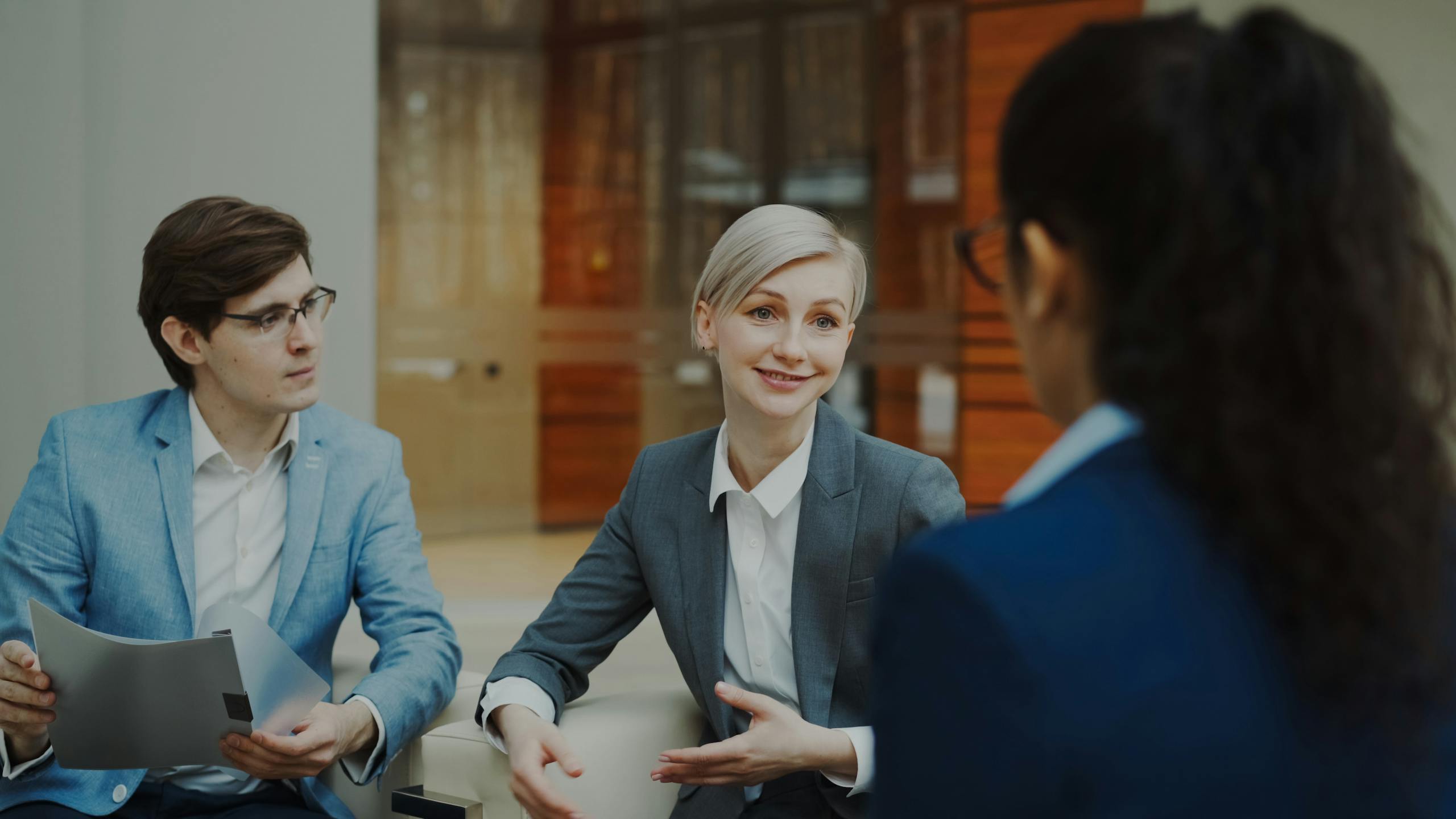 Group of professionals having a discussion in a modern office setting.