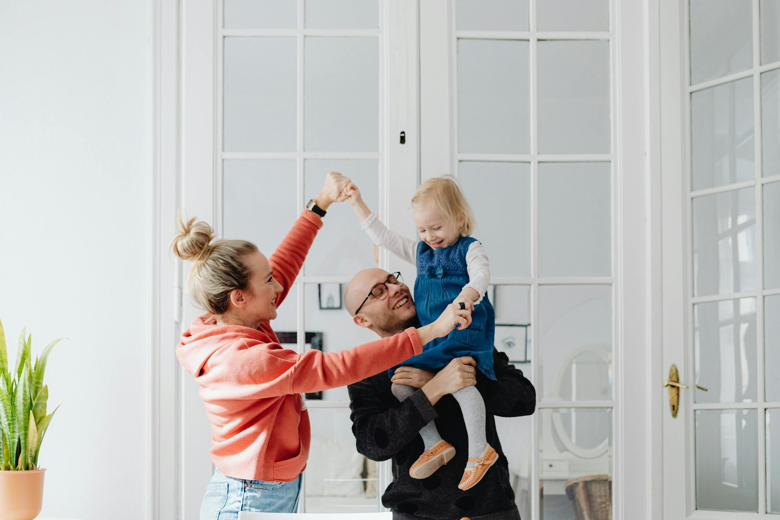 Happy family playing together indoors, capturing joyful moments and family bonds.