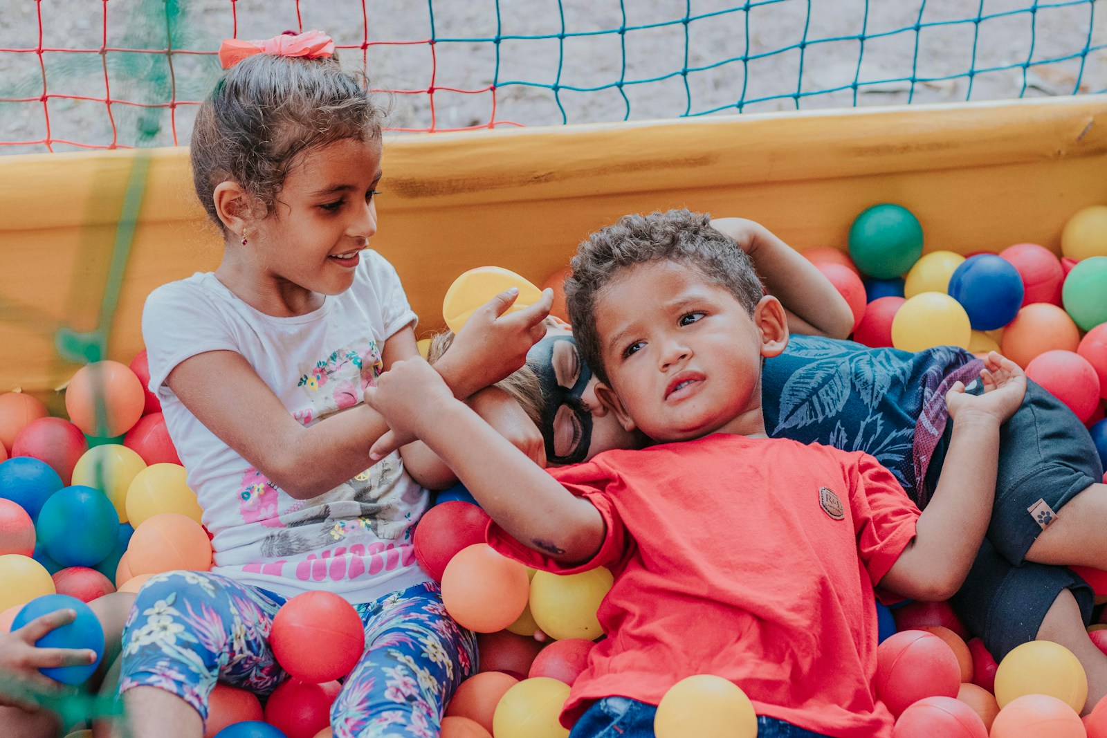 girl in pink shirt sitting beside girl in pink shirt
