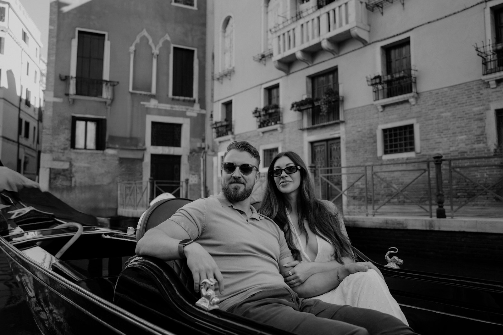 Couple enjoys a gondola ride in venice canal