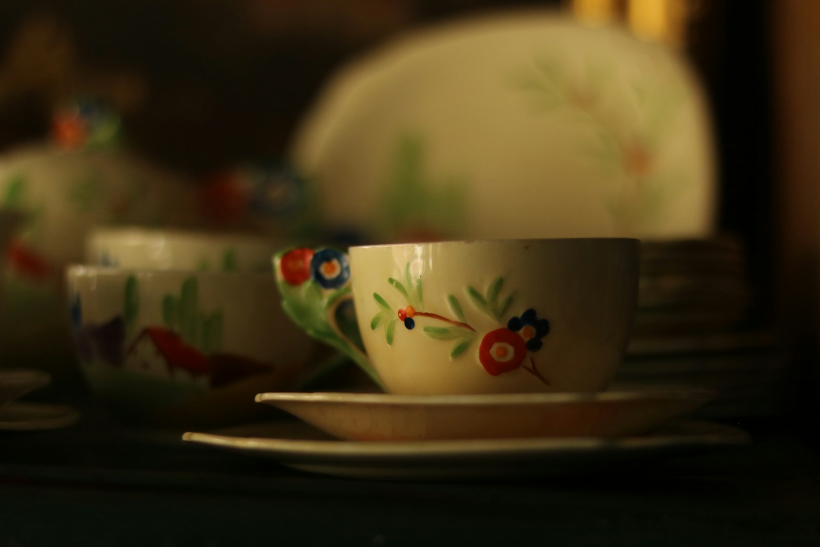 Two teacups with floral designs on saucers