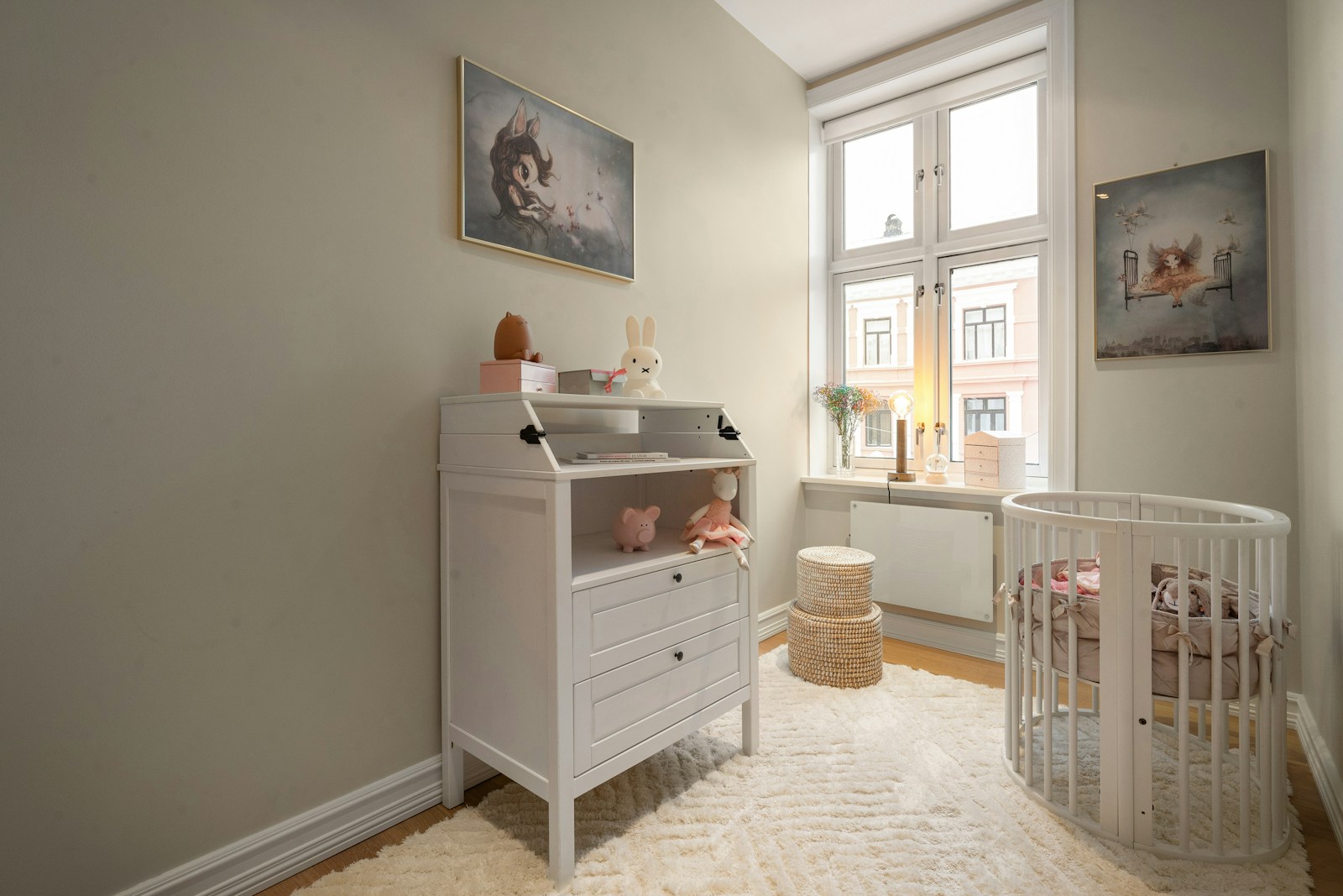 A baby's room with a crib and a dresser