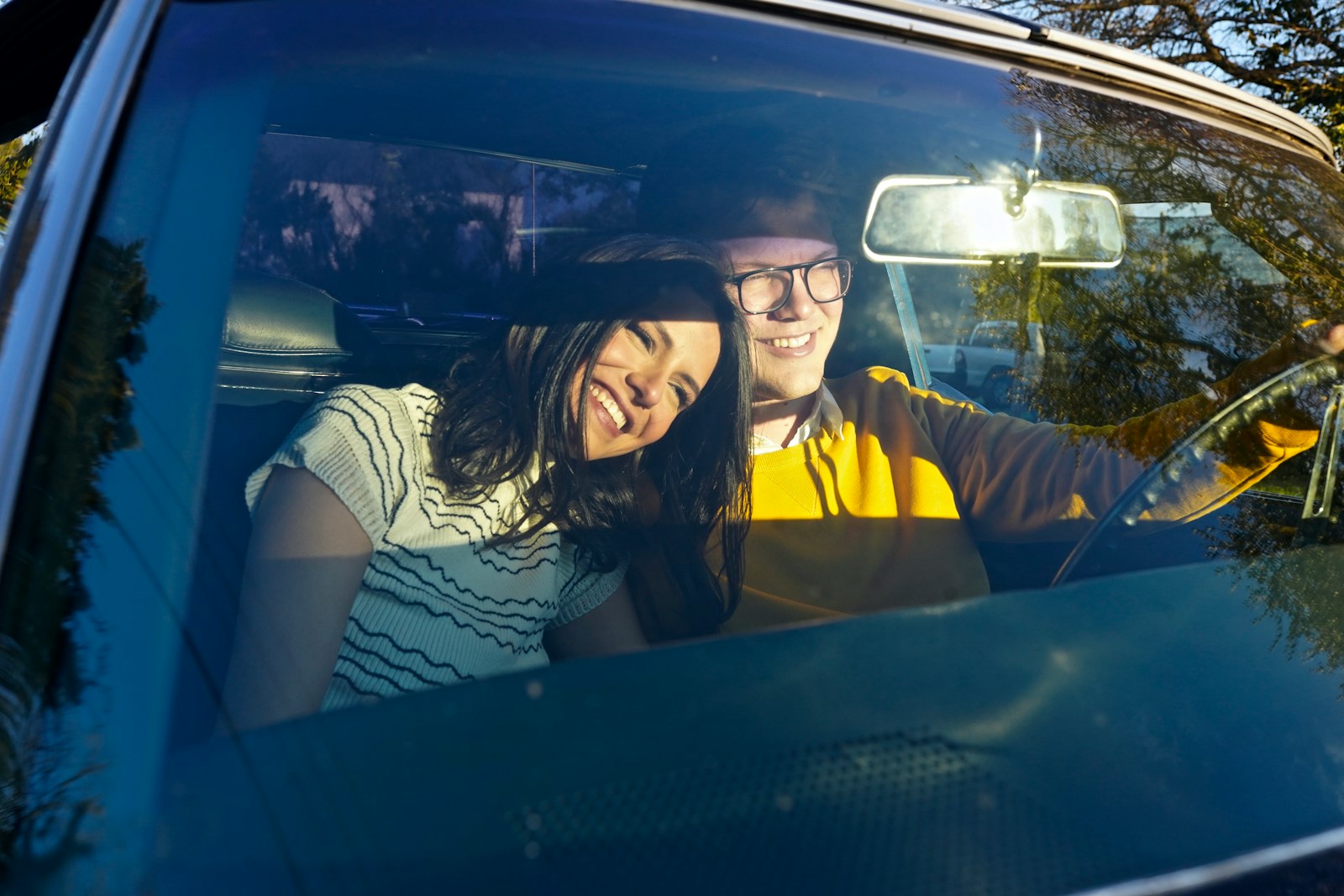 a man and a woman sitting in a car