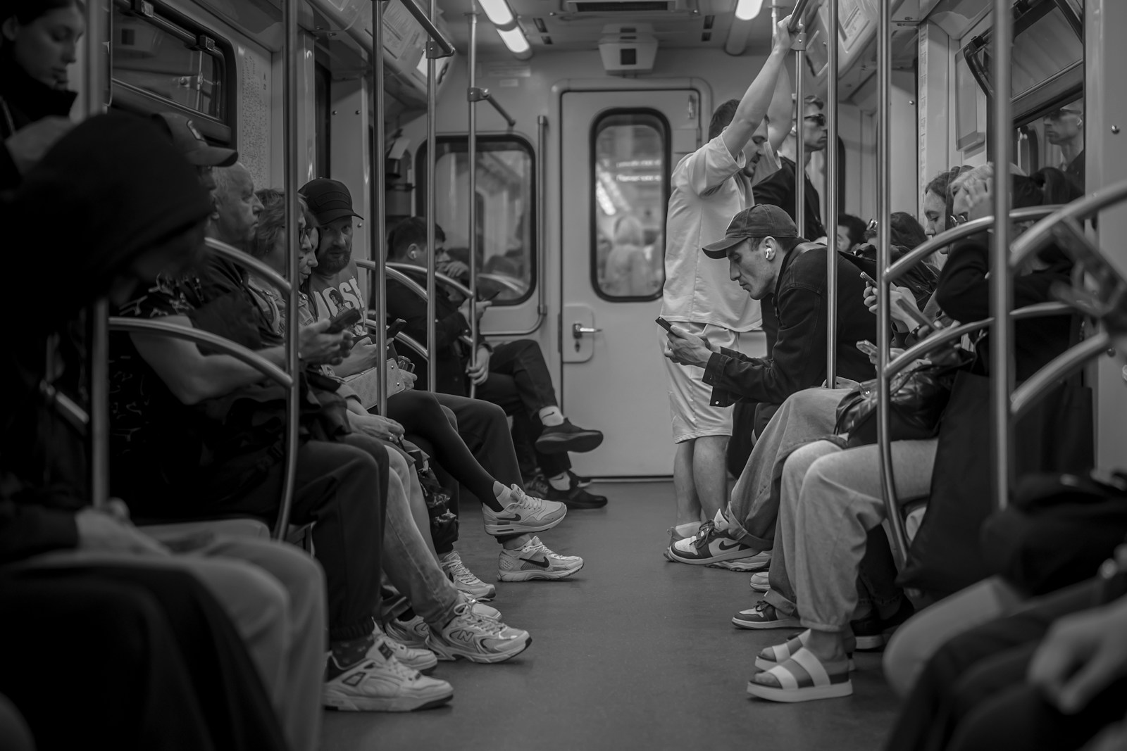 People ride a packed subway train.