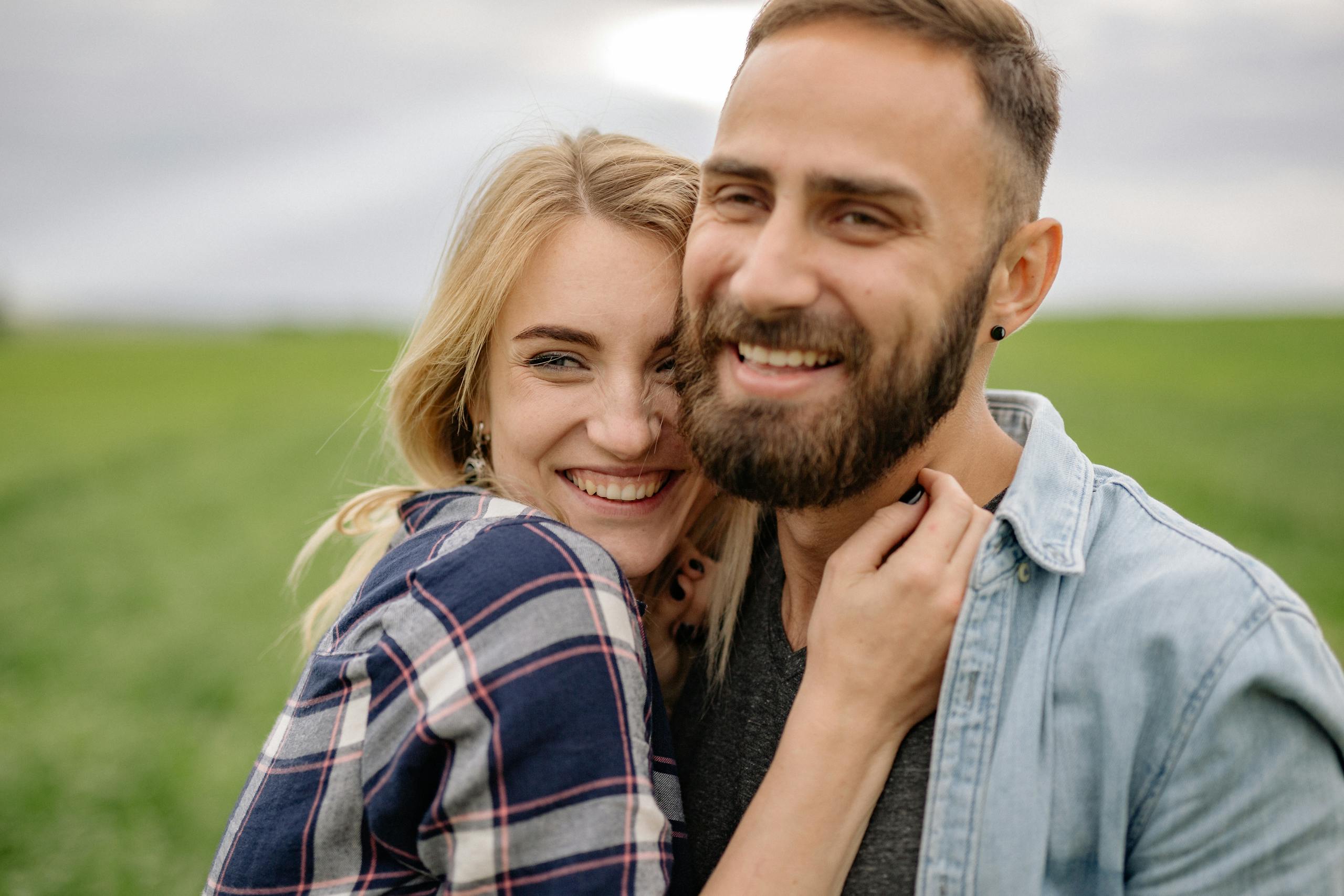 Smiling couple enjoying a loving moment outdoors in nature.