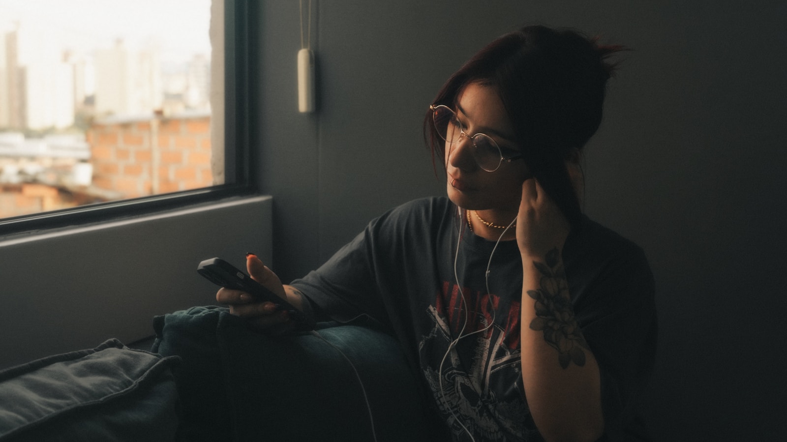 A woman sitting on a couch holding a cell phone to her ear
