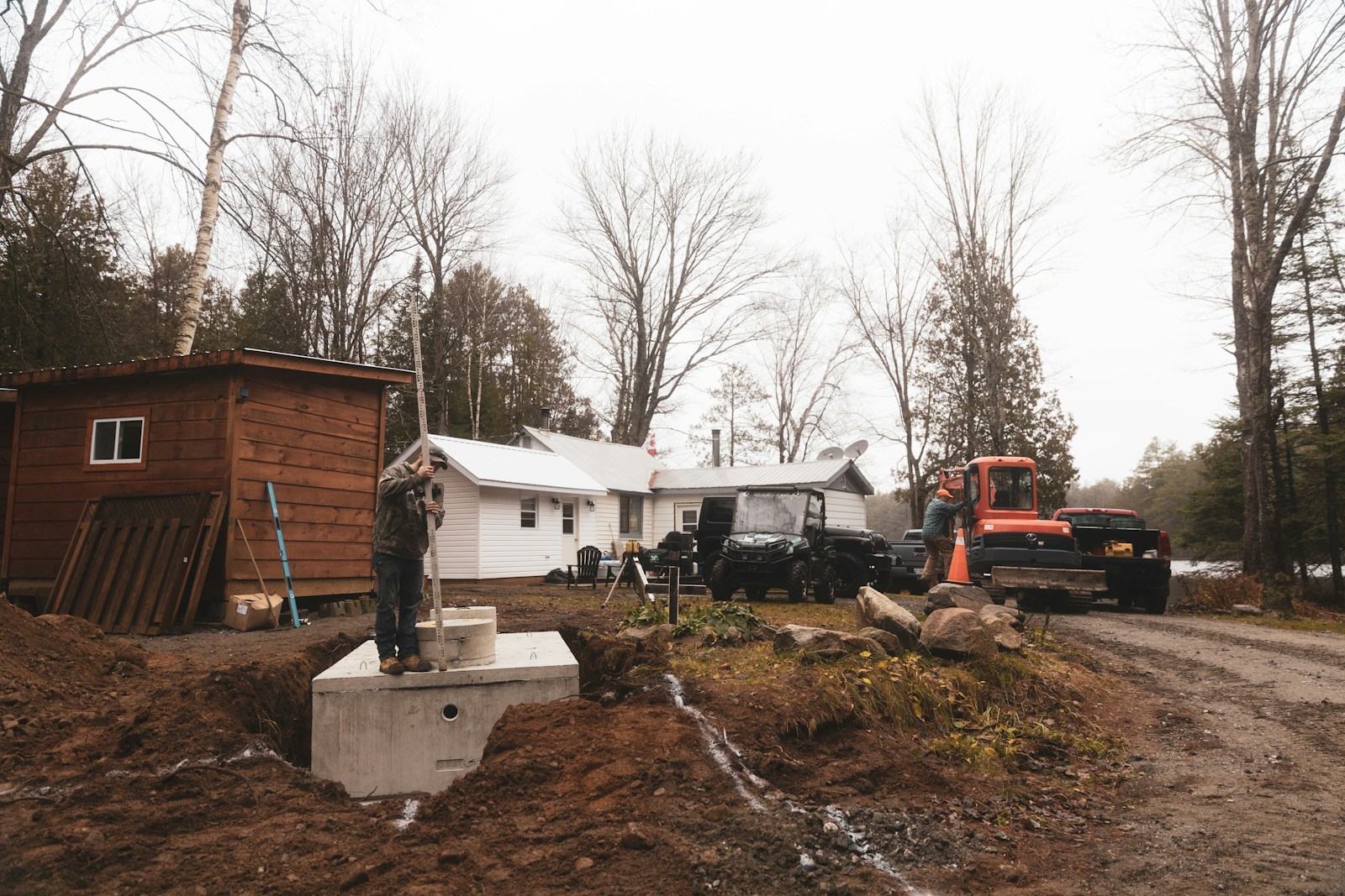 white and brown wooden house near bare trees during daytime