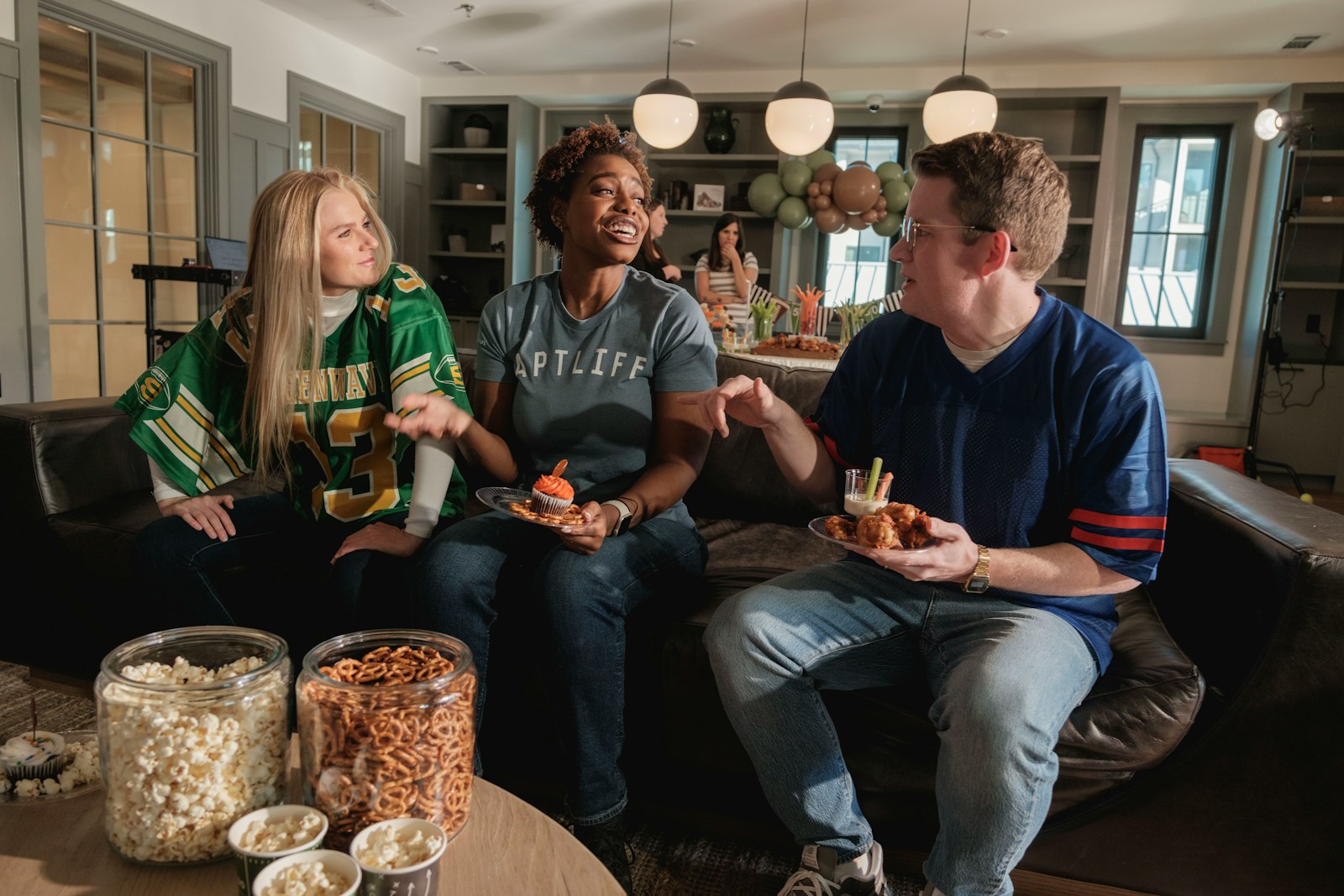 Friends watching sports and eating snacks