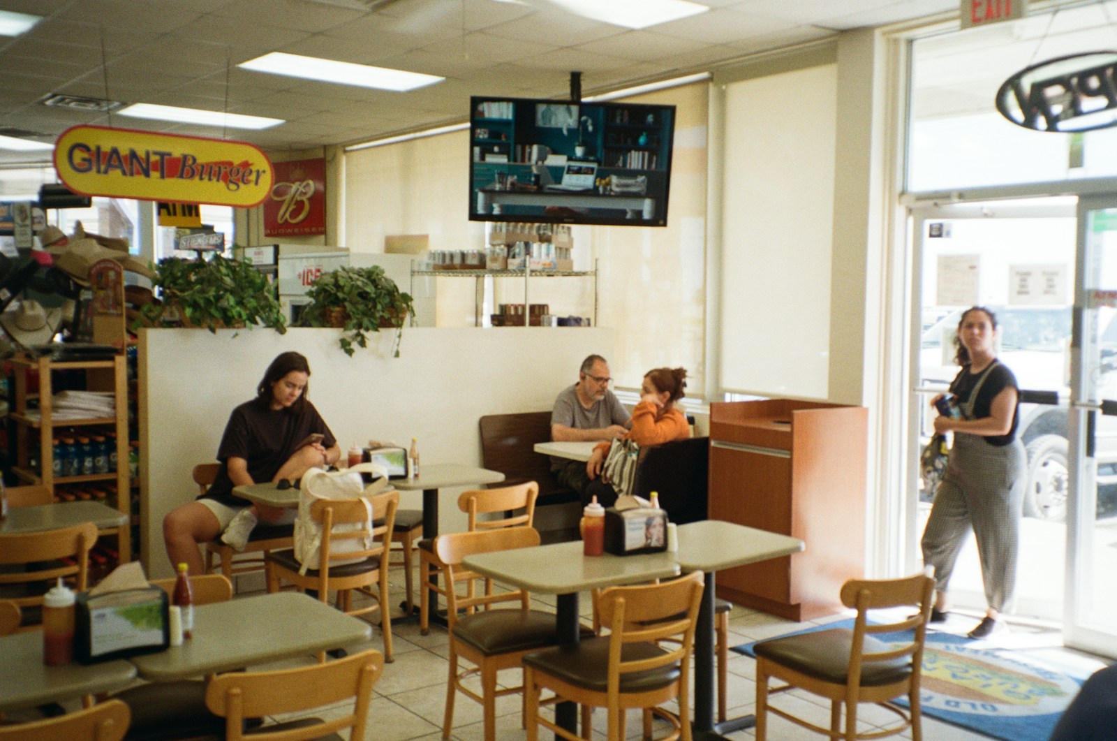 A group of people sitting at tables in a restaurant