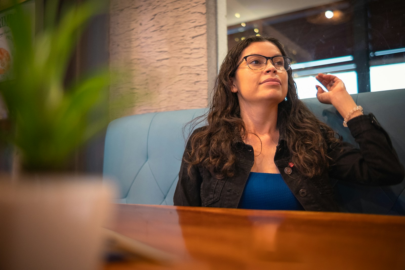 A woman sitting at a desk smoking a cigarette
