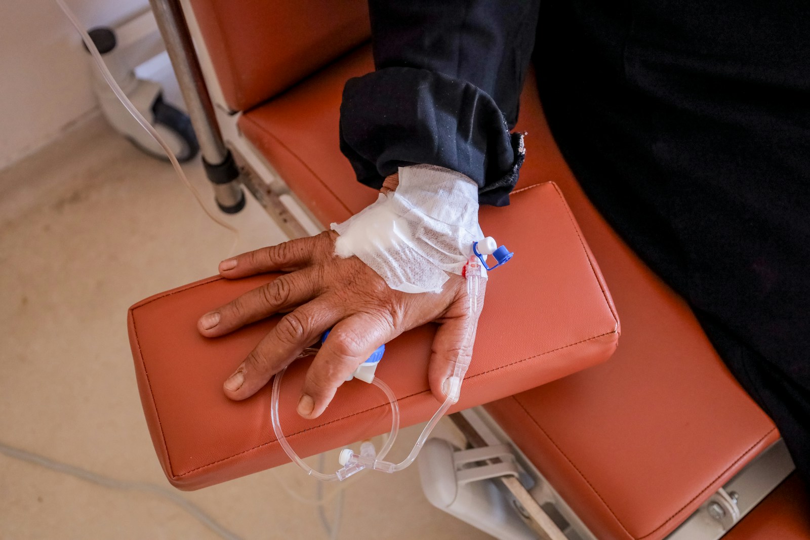 A person with a cast on their hand sitting in a chair