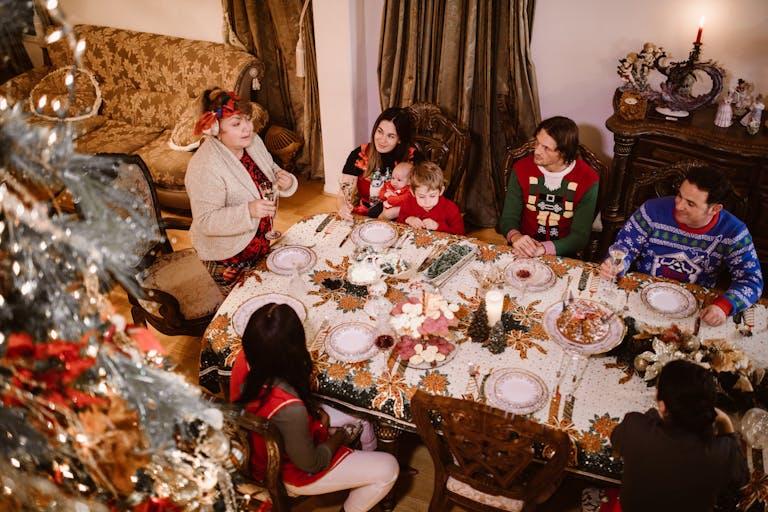 Festive family gathering around Christmas dinner table with cozy ambiance and holiday decor.