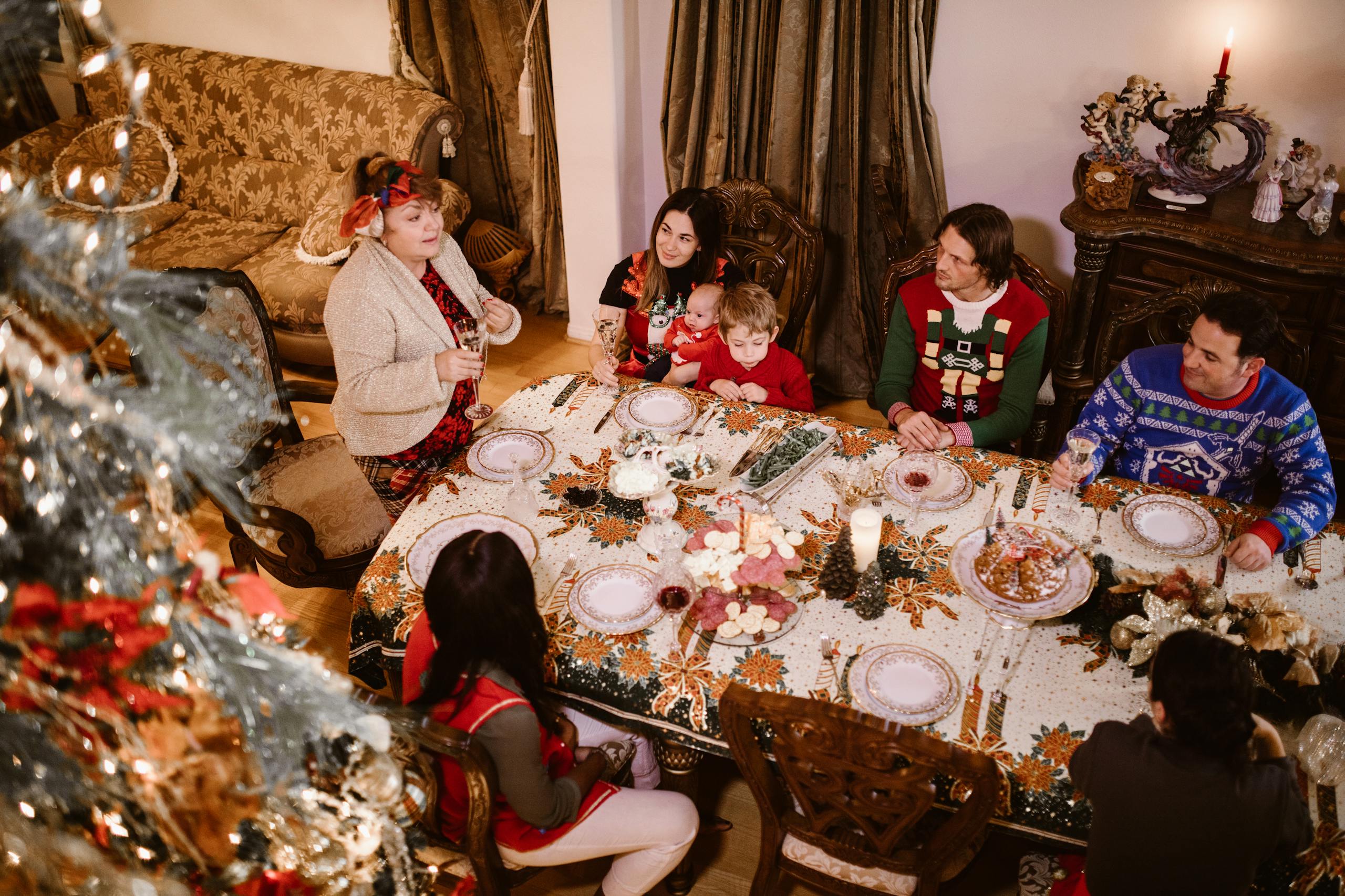 Festive family gathering around Christmas dinner table with cozy ambiance and holiday decor.