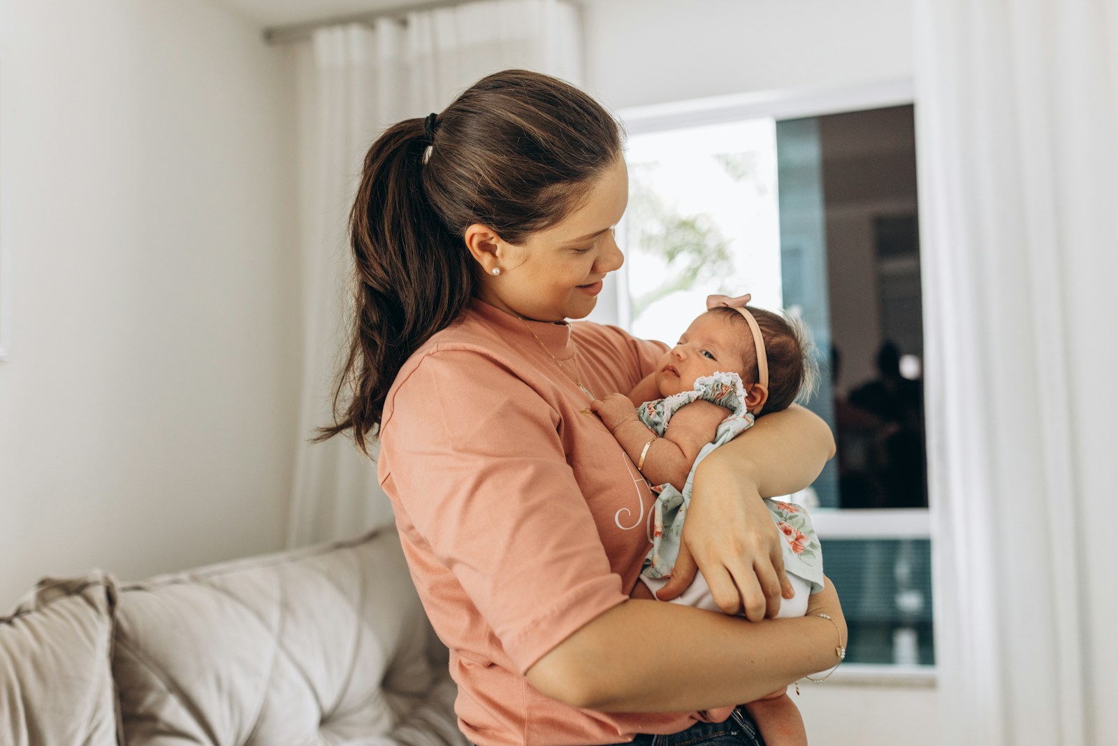 a woman holding a baby in her arms