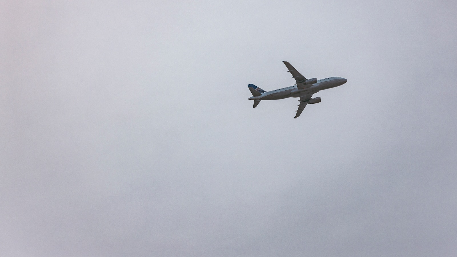 gray airplane flying in the sky