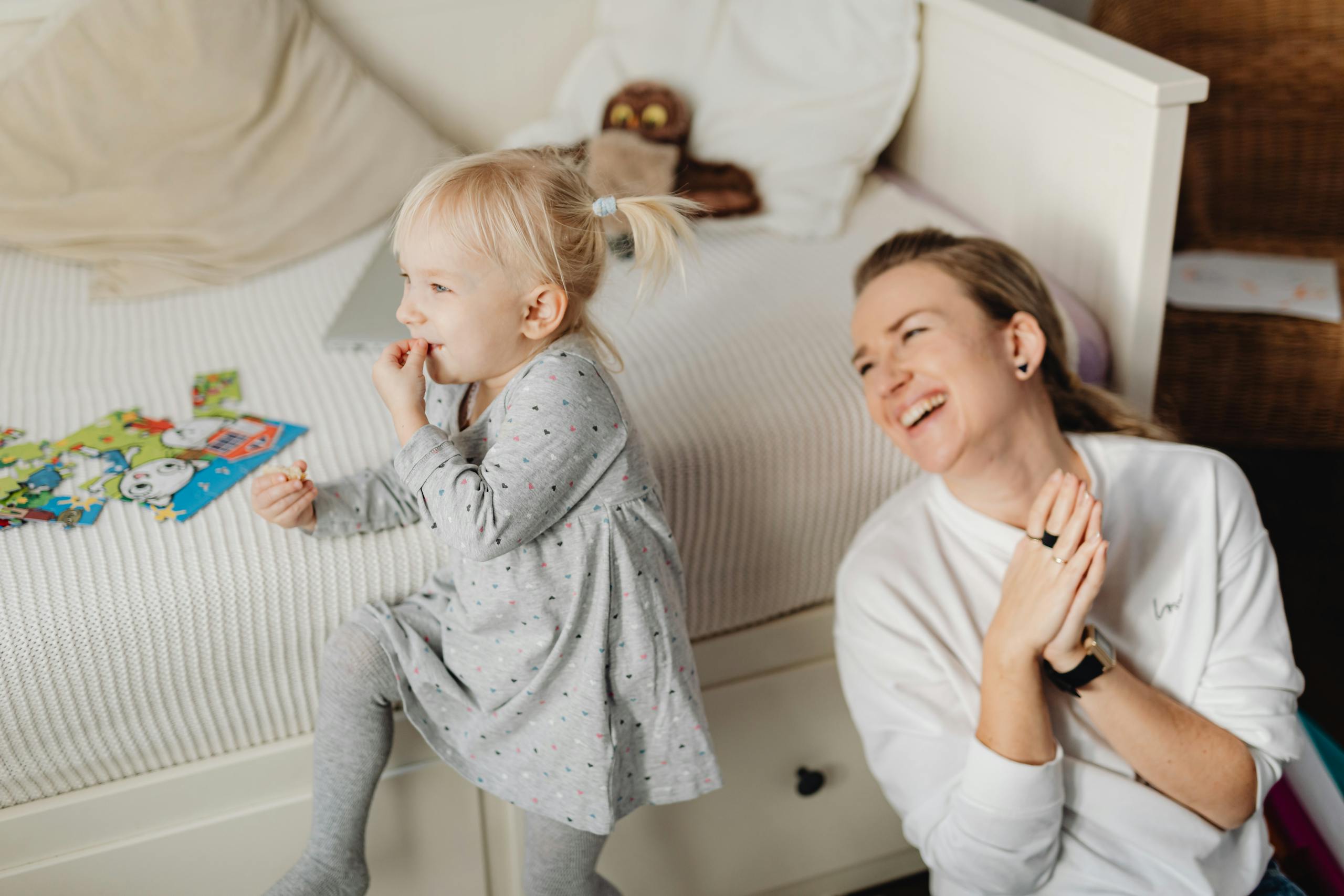 Joyful mother and daughter bonding during playtime indoors. Captured in a cozy home environment.