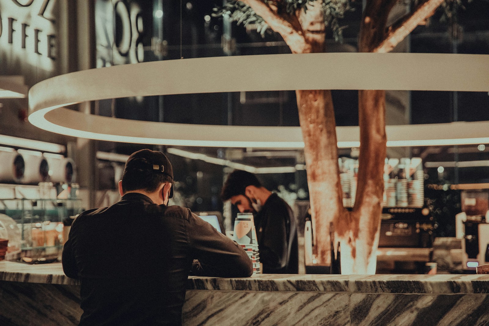 a man sitting at a counter in a restaurant