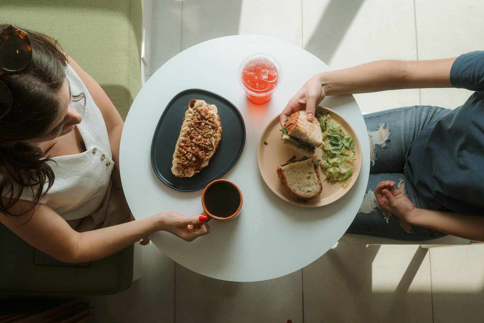 A woman sitting at a table with a plate of food
