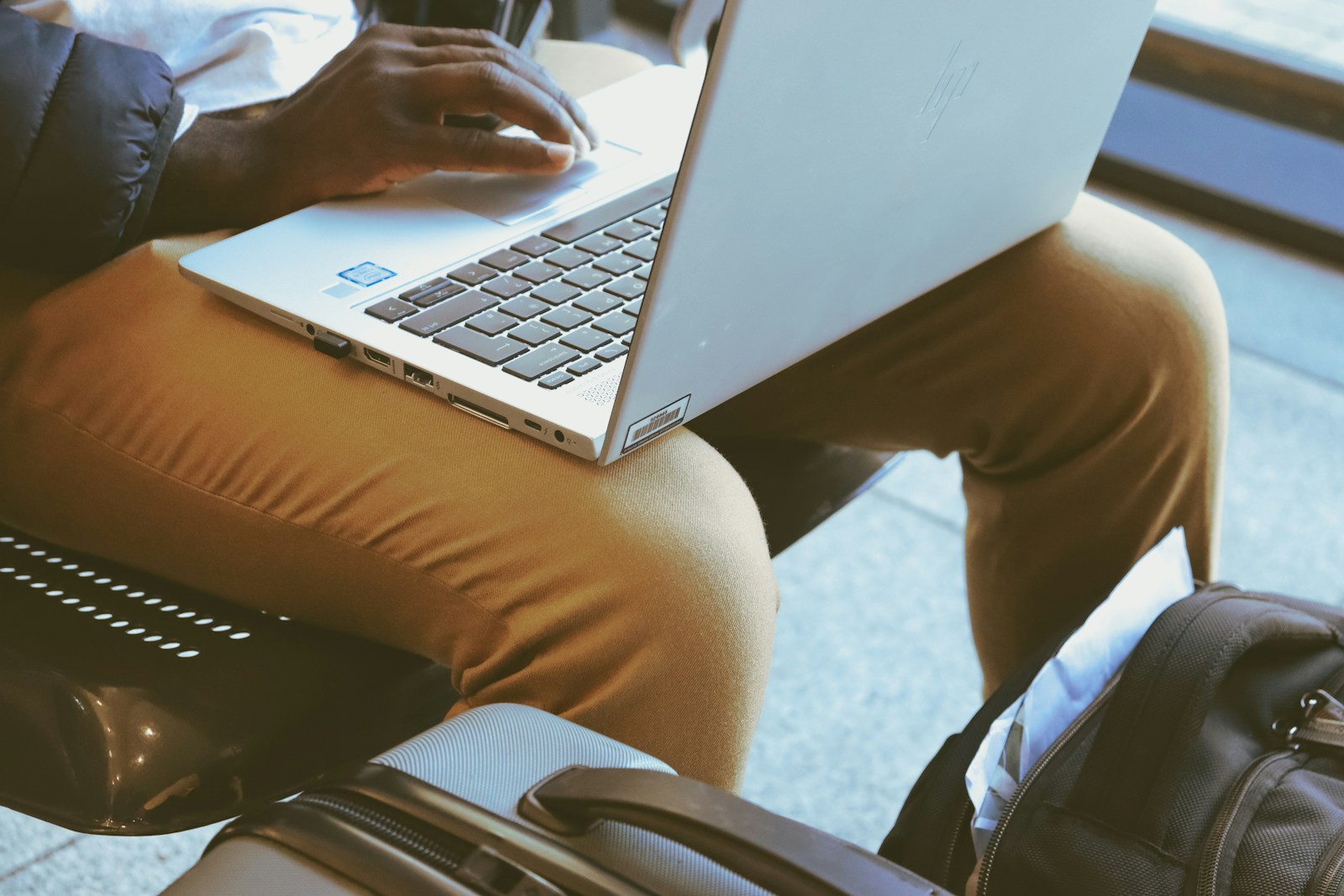a person sitting on a chair with a laptop
