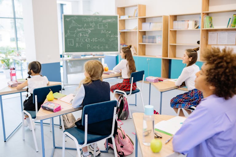 Students attentively participating in a school classroom environment.