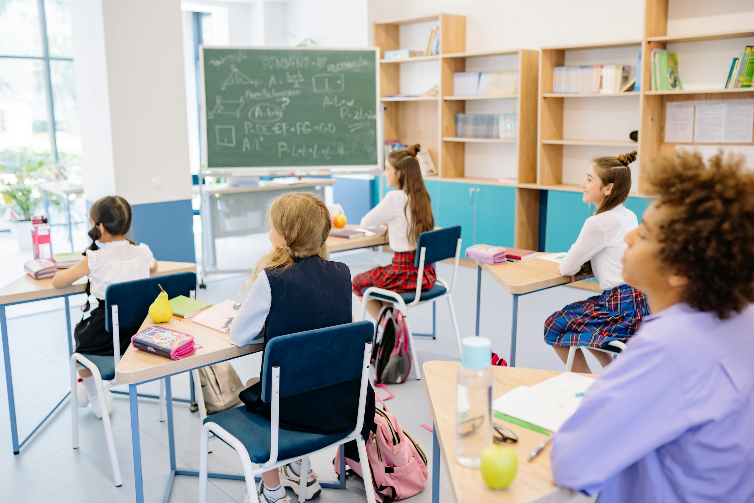 Students attentively participating in a school classroom environment.