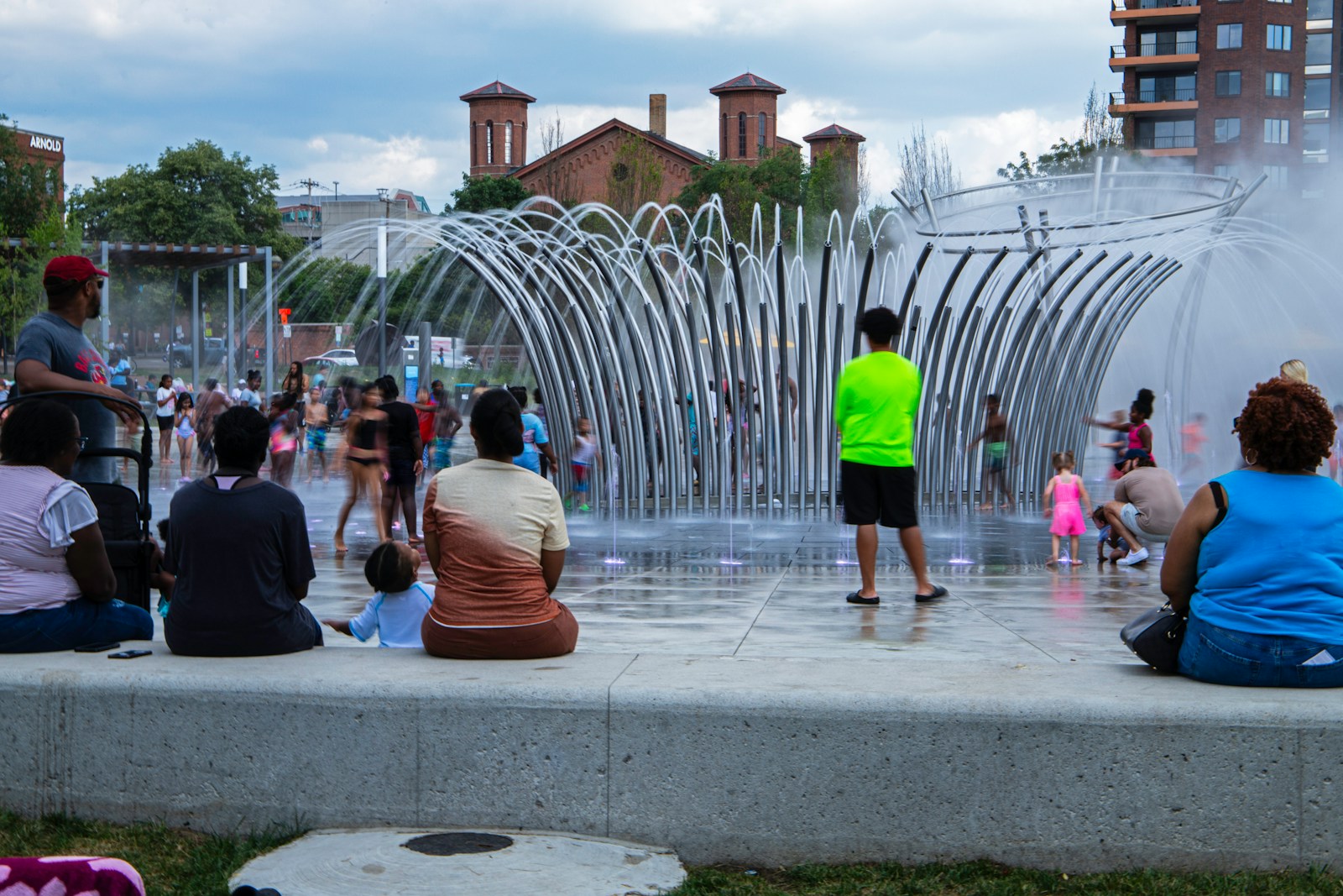 A group of people sitting in front of a water fountain