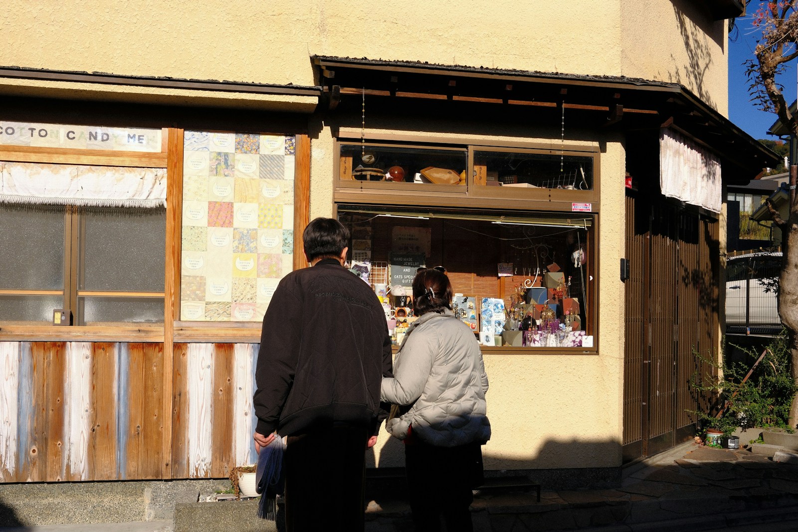 Two people look into a shop window