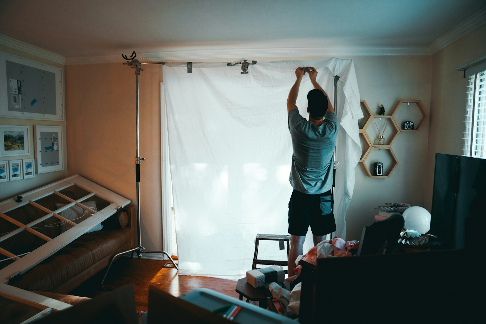 man standing beside white curtain