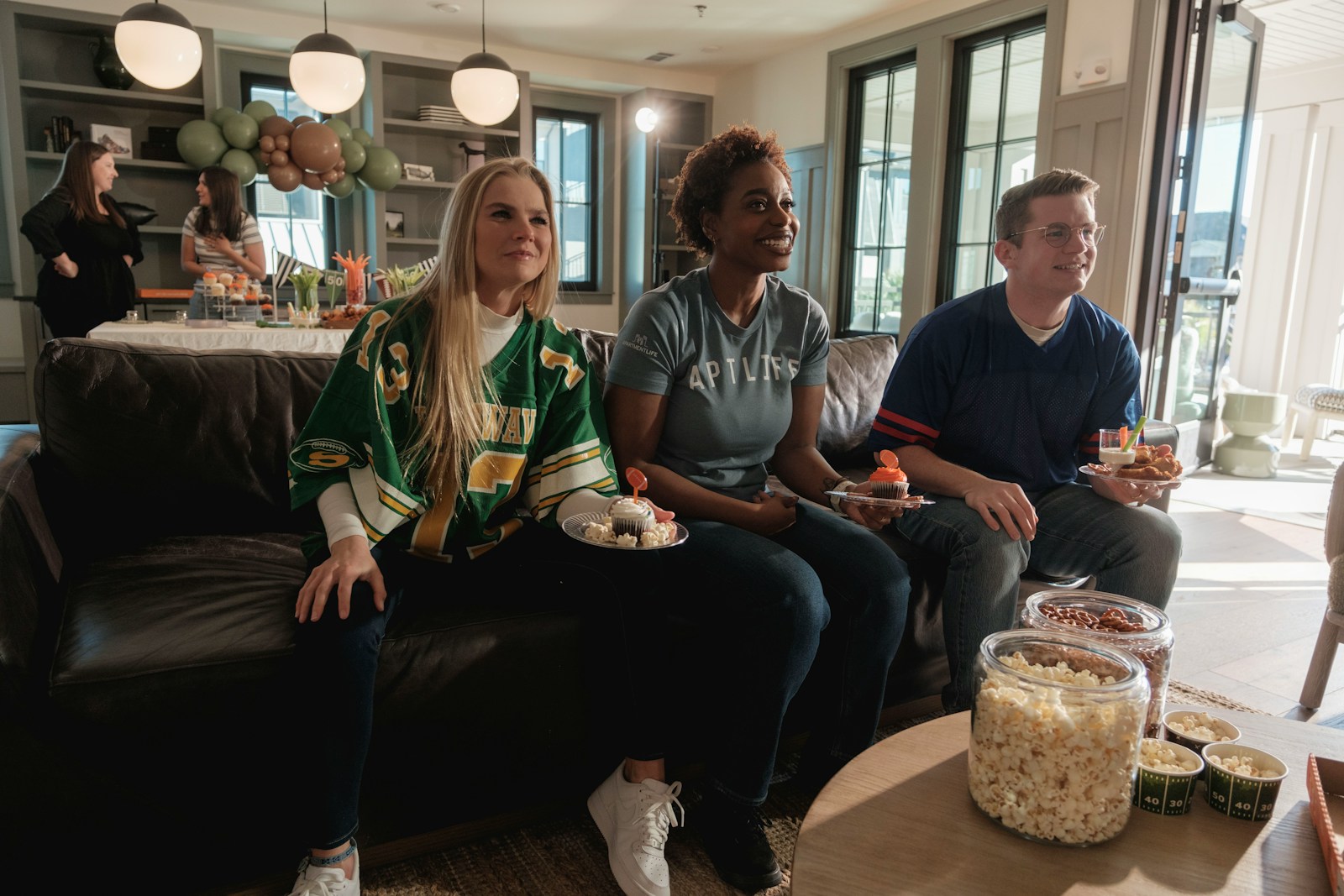 Friends watching a game on the couch