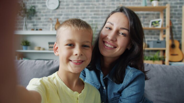 Mother and son taking a selfie on the couch.