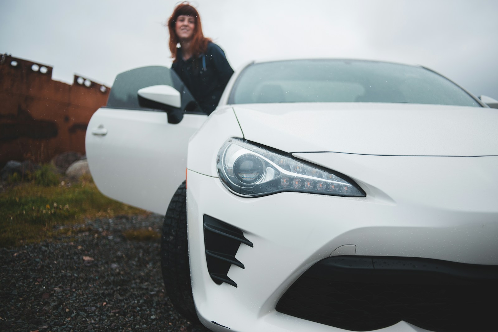 girl near white vehicle during daytime