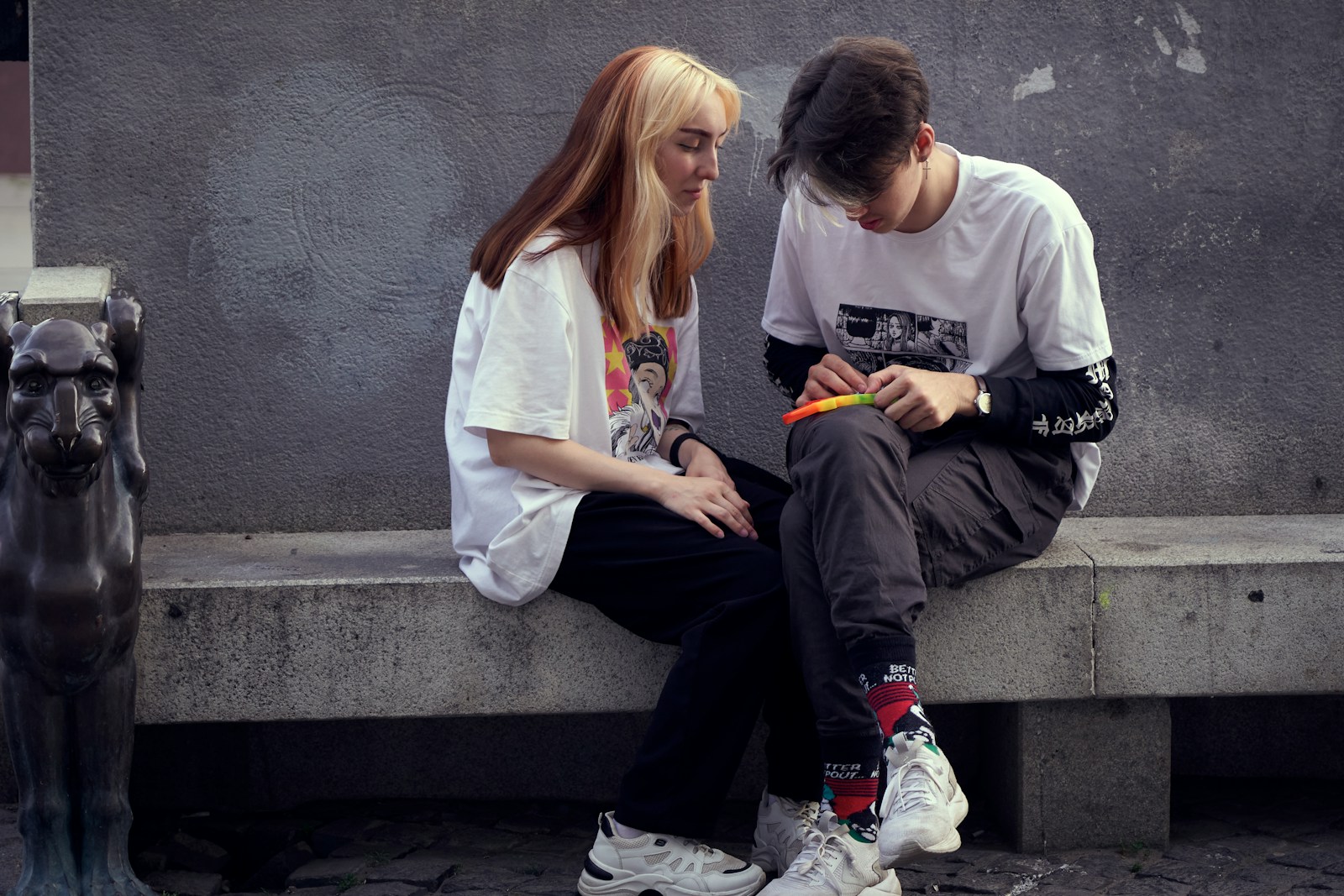 man in white crew neck t-shirt sitting beside woman in white crew neck t-shirt
