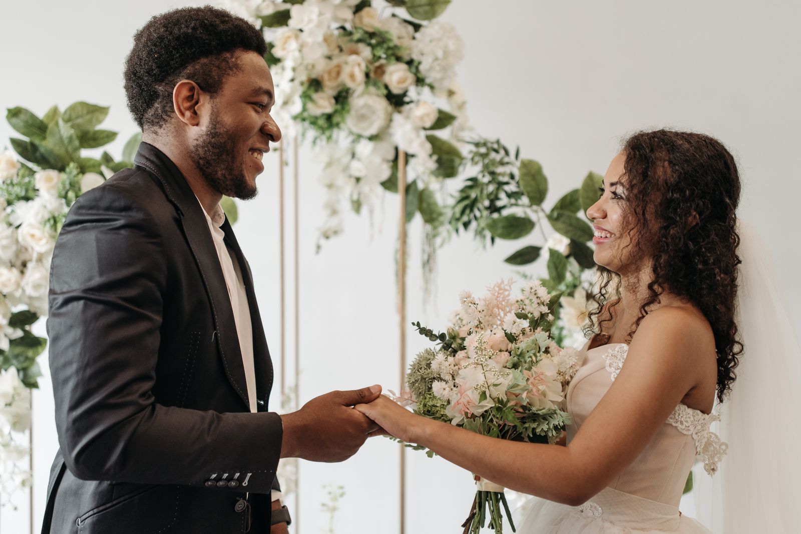 Beautiful wedding ceremony scene with happy couple holding hands and exchanging vows.