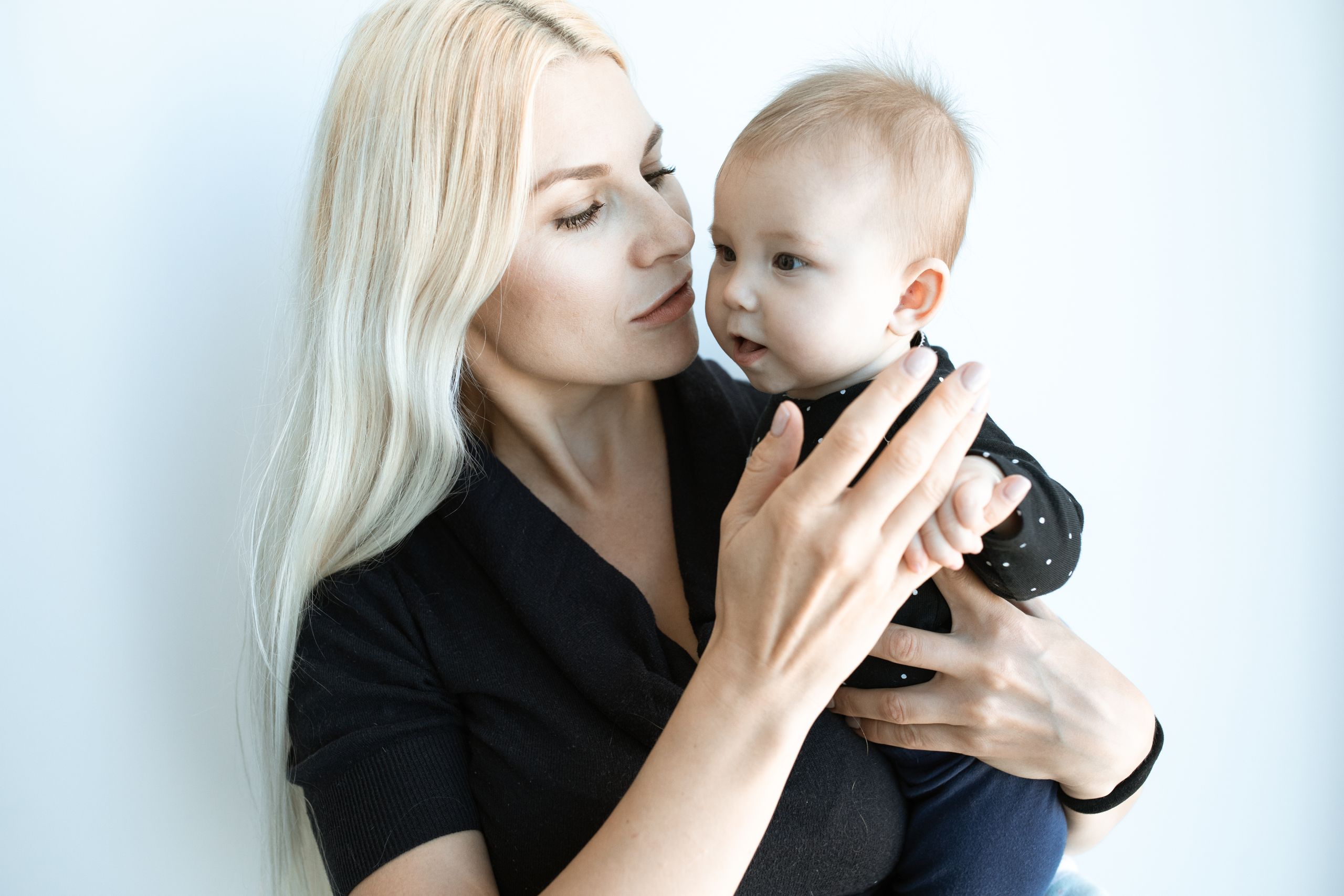 A tender moment of a mother holding her baby, showing love and connection.