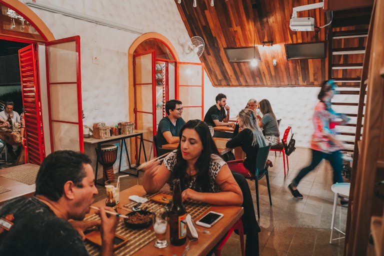 Casual dining scene in a rustic restaurant with people enjoying meals.