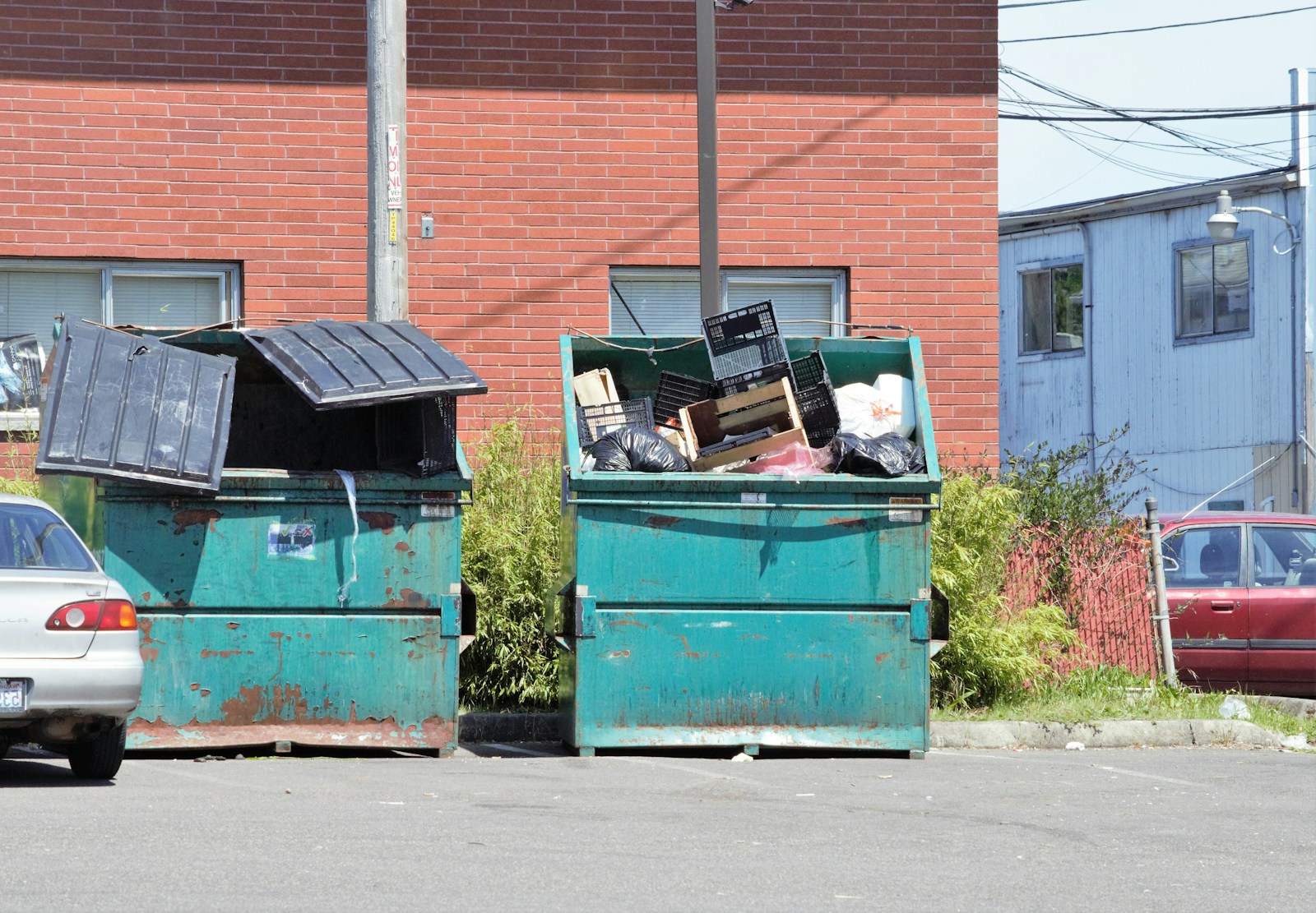 a couple of trash cans sitting in the middle of a street