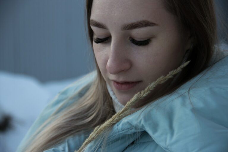 girl in blue hoodie with white earbuds
