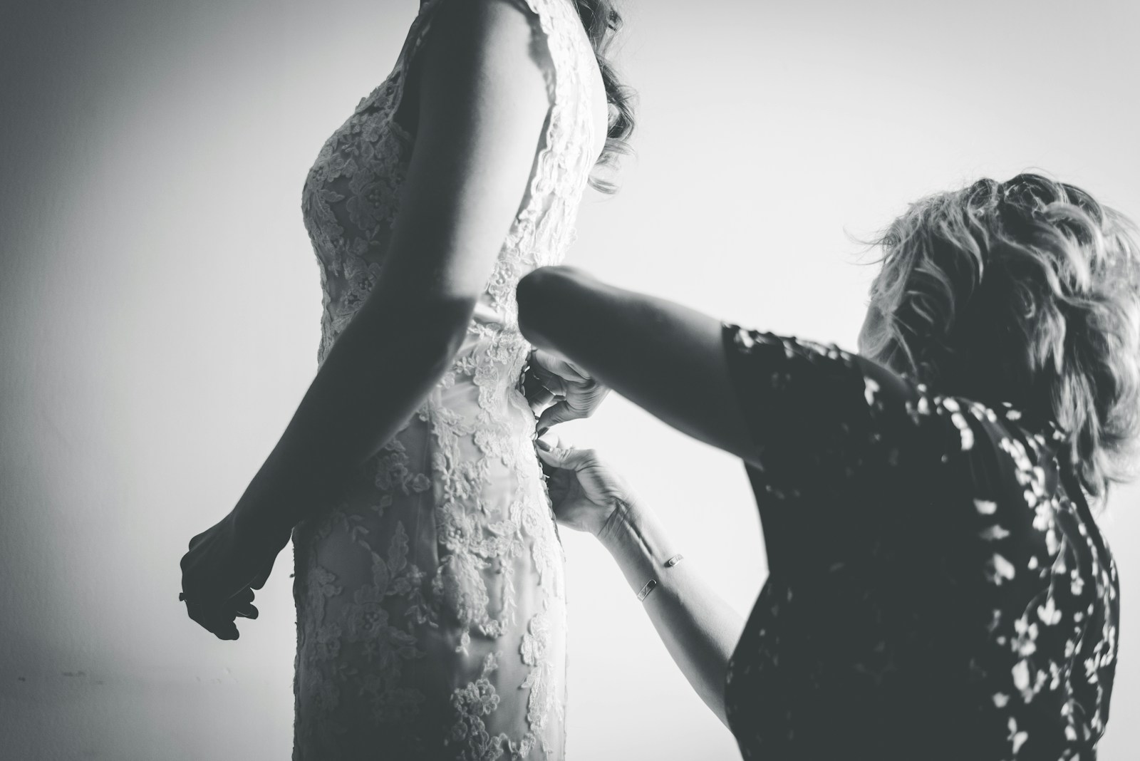 woman in black dress holding her hair