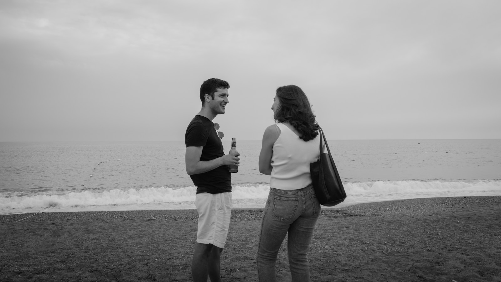 Two people chat at the beach.